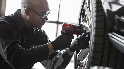 Technician servicing the tire at Rio Motors co GMC