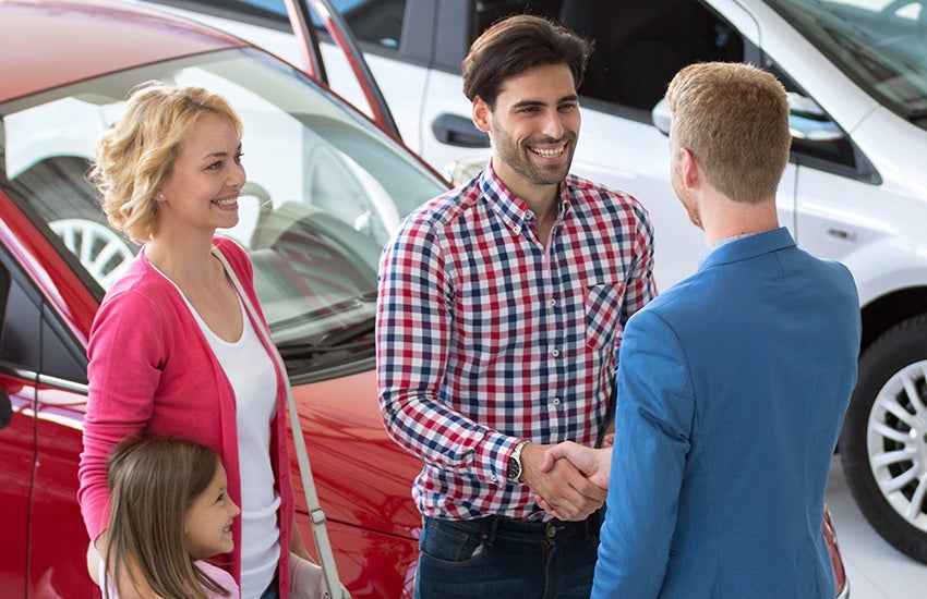 Family working with sales person